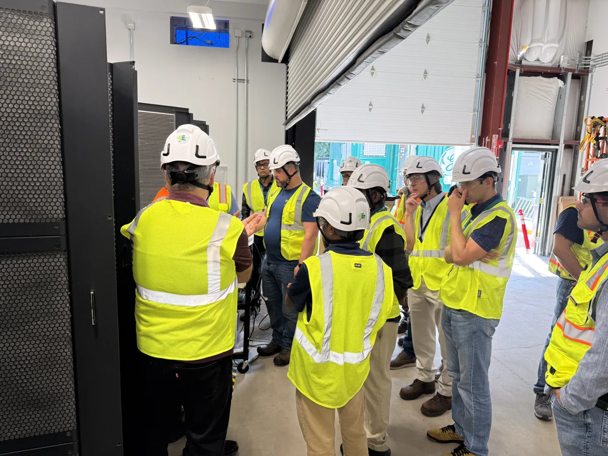 ElecTrain training participants discussing electrical equipment together