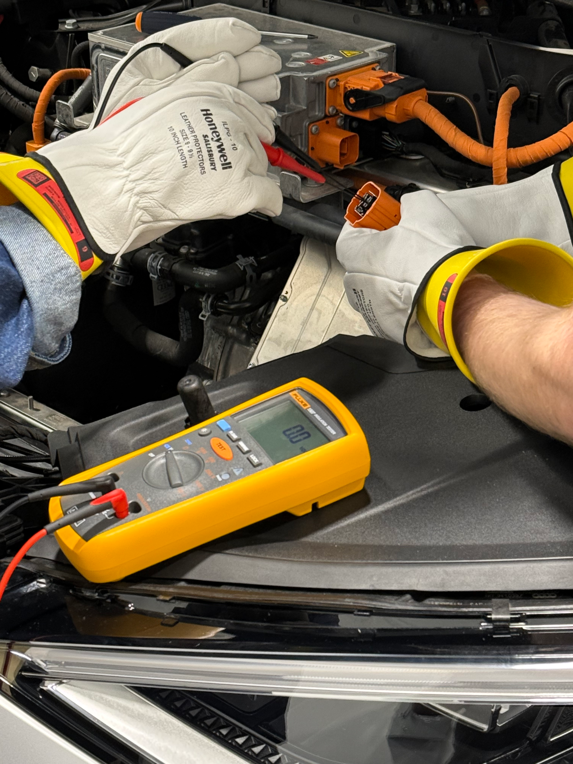 Multimeter and insulated gloves during ElecTrain EV connector training