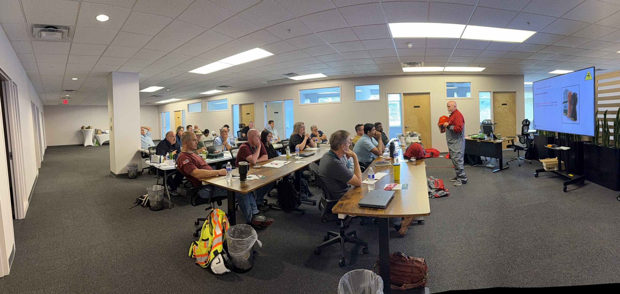 Wide view of participants attending an electrical safety equipment demonstration.